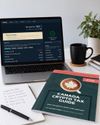 A laptop showing a Koinly tax report next to the Canada Crypto Tax Guide, a coffee mug and a handwritten crypto tax plan